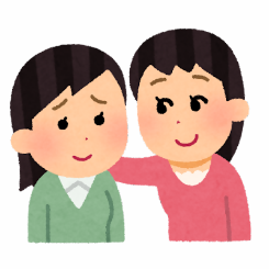 右の人が左の人の肩に手を置き、寄り添うように並んでいる様子