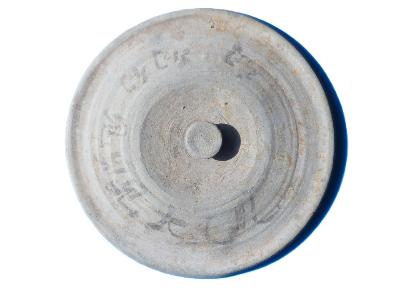 丸形で蓋状の突起が中央についた、墨で文字が書かれた灰色の土器の画像