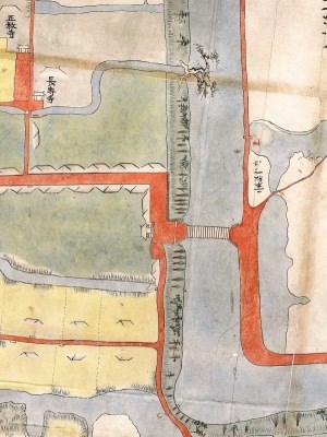 江戸時代の「巨勢郷牛嶋村絵図」の一部が拡大され、中央を流れる川に架かる橋の西側に、赤い線で囲まれた番所や門などの遺構が詳細に描かれた古地図の画像。